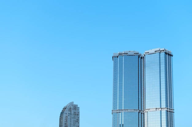 Modern buildings with stained glass windows against clear blue sky