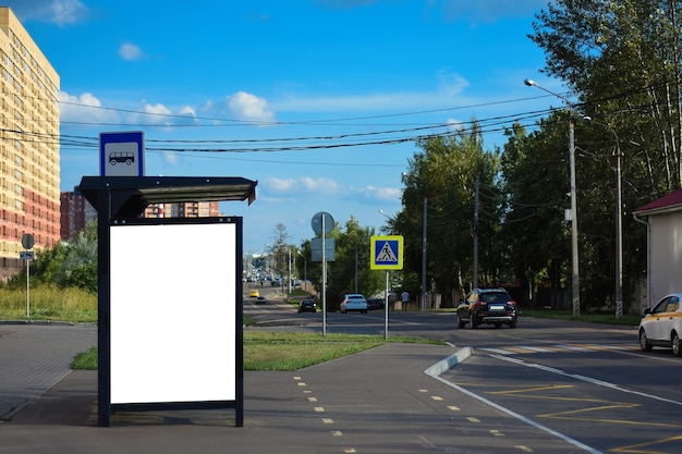 Modern bus stop with blank white poster Close up Mock up