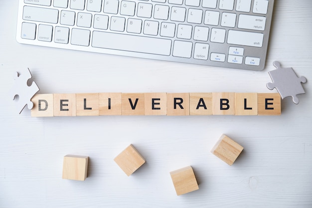 Photo modern business buzzword - deliverable on wooden blocks