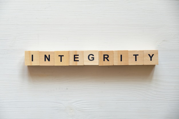 Photo modern business buzzword - integrity . top view on wooden table with blocks. top view.