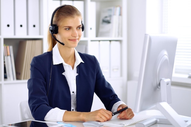 Modern business woman in headset the office.