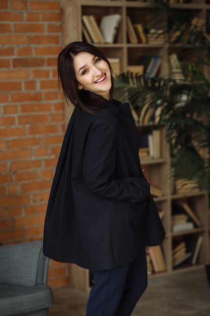 Modern business woman in the office sitting on the sofa