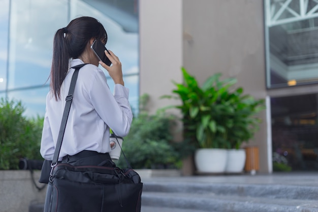 Modern business woman working with smartphone outdoor