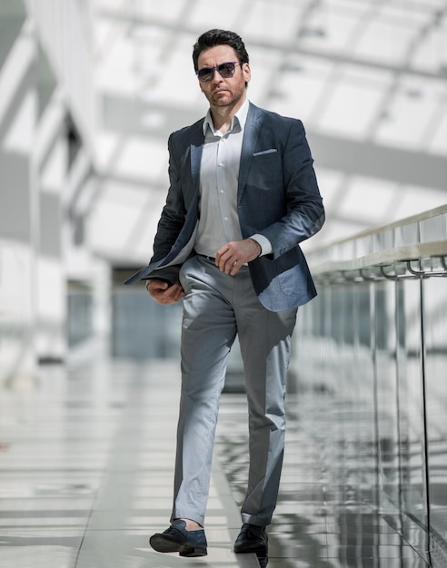 Modern businessman is walking in the airport building the concept of business trave