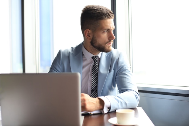 Modern businessman thinking about something while sitting in the office.