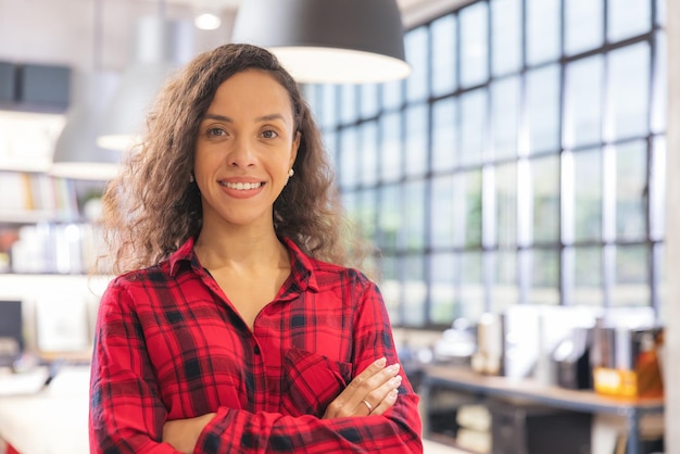 Modern businesswoman at the office, smiling female boss posing for a company photograph, self-assured successful woman at work