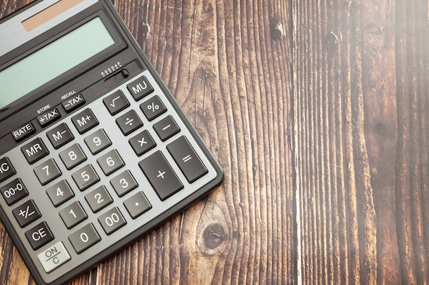 Modern calculator on wooden table