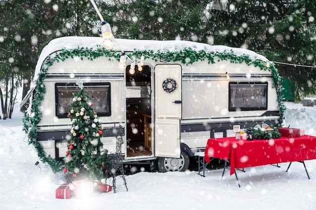 Modern campervan motorhome in winter camping decorated for xmas or happy new year holiday