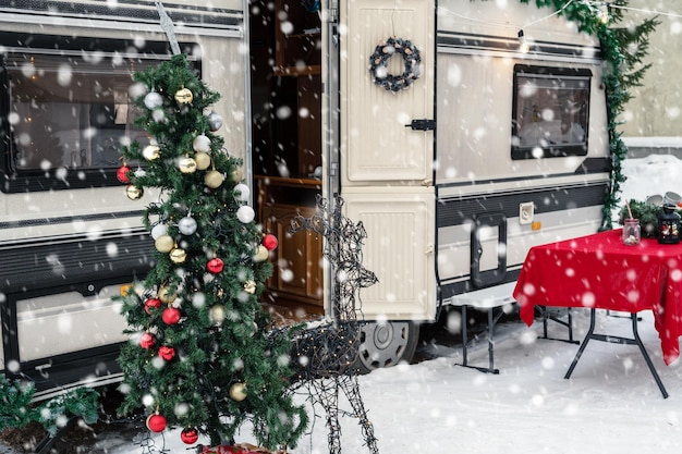 Modern campervan motorhome in winter camping decorated for xmas or happy new year holiday