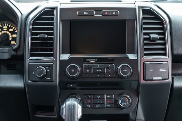 Modern car interior with multimedia display and dashboard. View from inside a car.