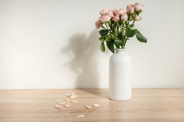 Modern ceramic vase with roses White wall background Scandinavian interior