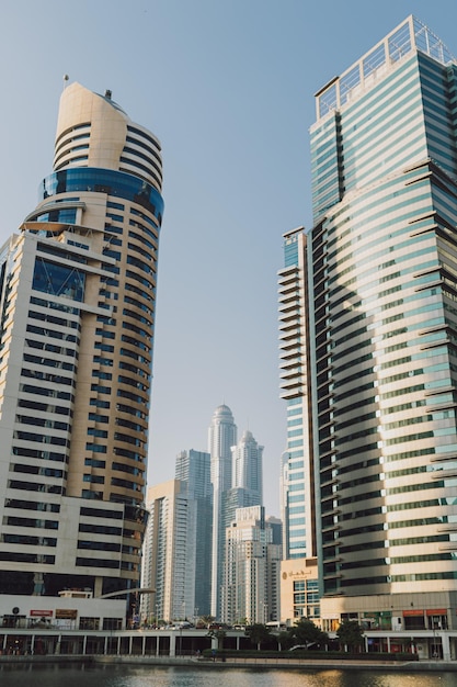 Modern city skyscrapers buildings at sunset time with business and residential towers around a lake