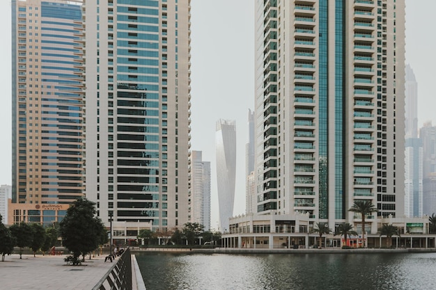 Modern city skyscrapers buildings at sunset time with business and residential towers around a lake