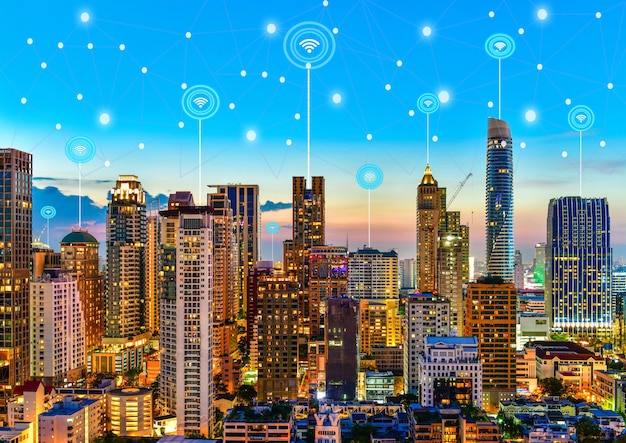 Modern city at twilight with network connection wireless communication concept