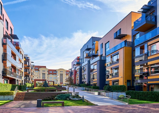 Modern complex of apartment residential buildings with benches and outdoor facilities.