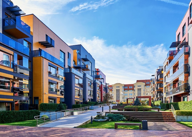 Modern complex of apartment residential buildings with benches and outdoor facilities.