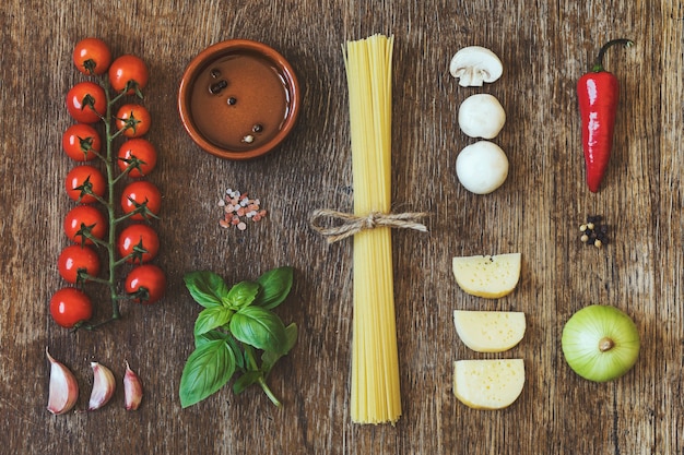 Modern composition of fresh food and ingredients on the vintage wooden table in the kitchen