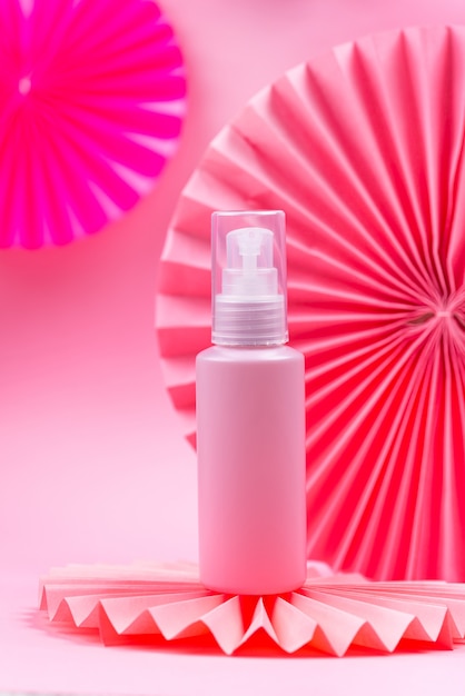 Modern composition with pink cosmetic bottle