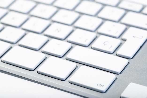 Modern Computer Keyboard background Aluminium and White keys Selective focus