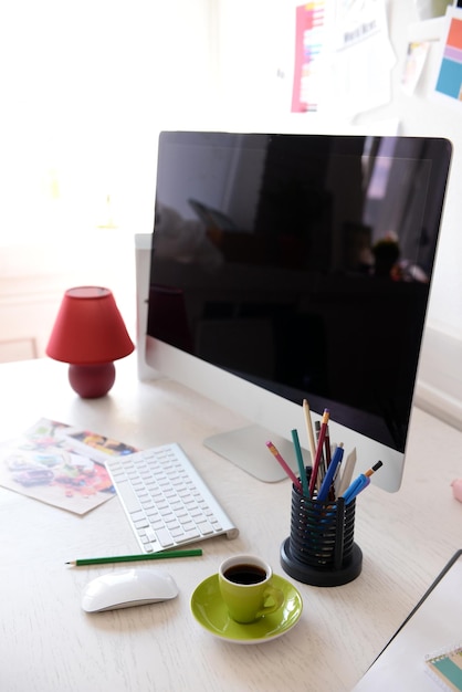 Modern computer on the table in decorated room