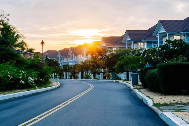 Modern cottages row road sidewalk two story buildings residential villas village New Estate Reflection dawn Sun in windows