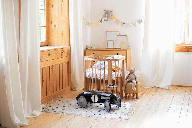 Modern Cozy baby room wooden children crib with bedding and toys