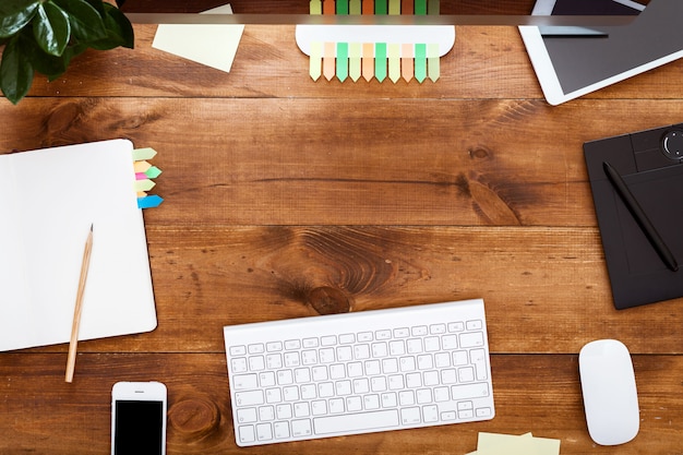 Modern creative design workplace concept, computer paints on brown wooden table