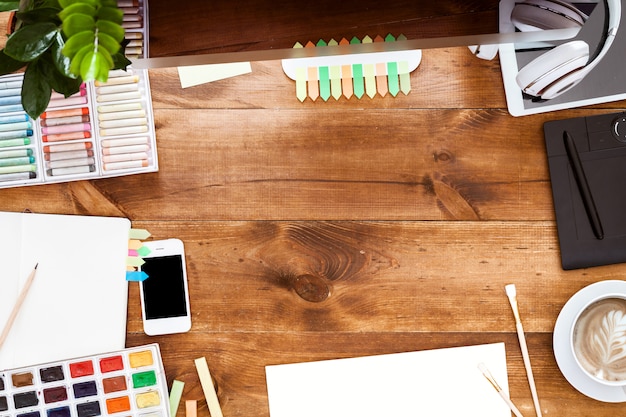 Modern creative design worktable concept, computer paints on brown wooden table