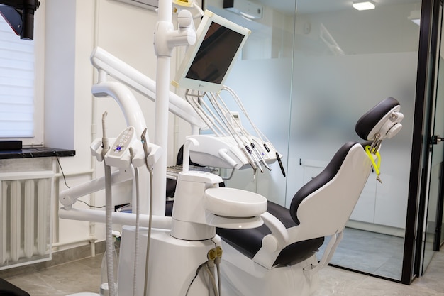 A modern dental office with new equipment and a dental chair. Cabinet for dental treatment