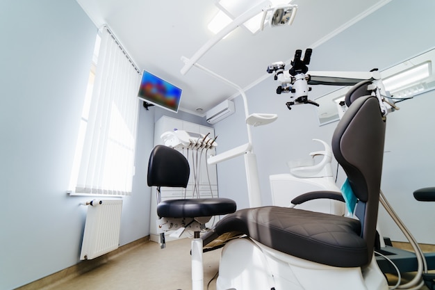 Modern dentistry office interior with chair and tools