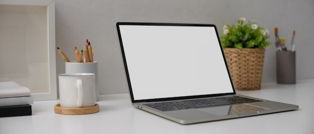 Modern desk with laptop with white screen