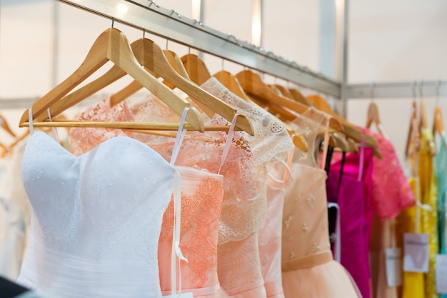 Modern dresses on the coat-hangers in the shop