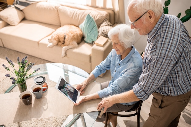 Modern Elderly Couple Using Digital Tablet