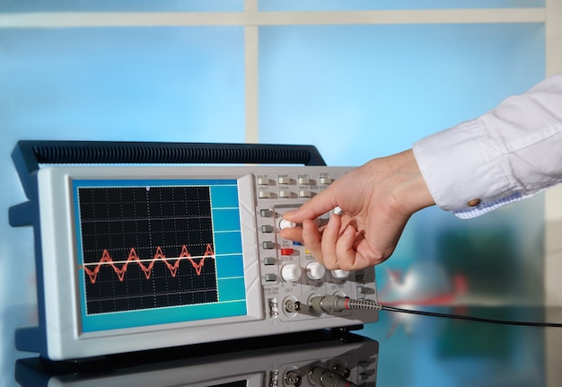 Modern electronic oscilloscope on abstract