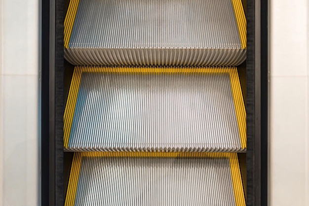 Modern escalators stairway view from the top Move Terminal Supermarket Automatic Electric Interior Industry Manufacture Production Traffic Market Commerce Shop Public