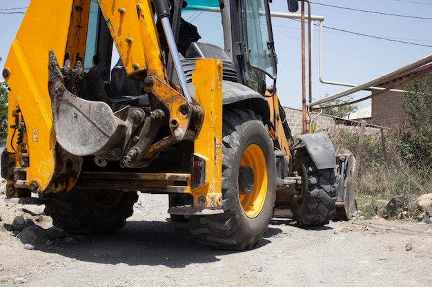 Modern excavator stands on the street