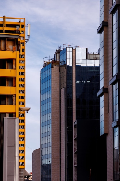 The modern facade of the office building is an abstract fragment, with shiny Windows in a steel structure. 