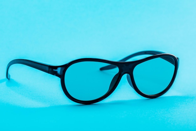 Modern fashionable and office spectacles isolated on blue background