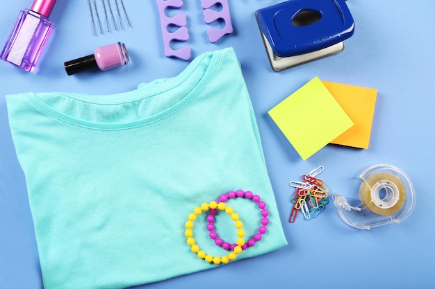 Modern female clothing and accessories on color background