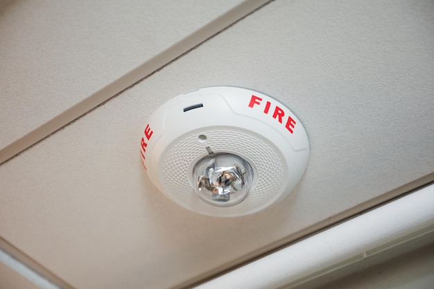 modern fire alarm system inside a building with red warning lights and control panel emphasizing s