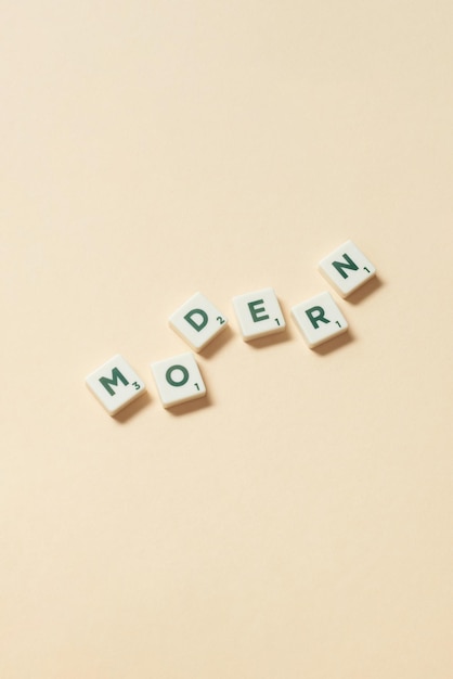 Modern formed of scrabble tiles on beige background