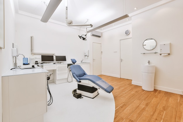 Modern furniture and professional equipment located in light office of contemporary dental clinic