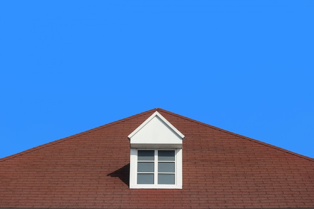 Modern gable roof design house wall with clear blue sky background.