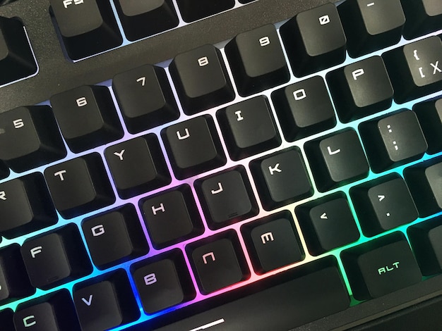 Modern gaming keyboard with bright backlit keys on the table