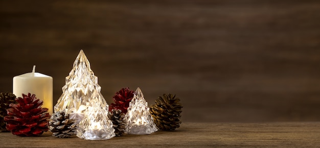 Modern glass Christmas tree with lights on wood table with wall for merry chirstmas and new year