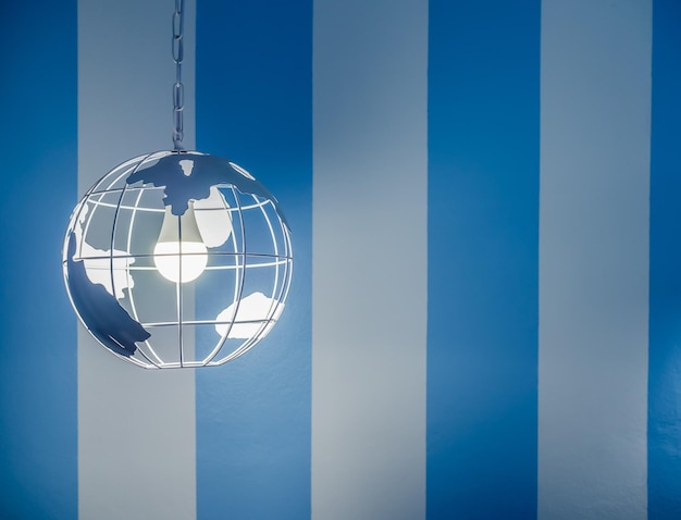 Modern global earth world shape ceiling lamp on white and blue stripe wall background