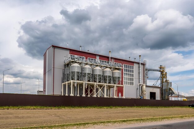 Modern Granary elevator and seed cleaning line Silver silos on agroprocessing and manufacturing plant for processing drying cleaning and storage of agricultural products flour cereals and grain