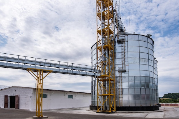 Modern Granary elevator Silver silos on agroprocessing and manufacturing plant for processing drying cleaning and storage of agricultural products flour cereals and grain