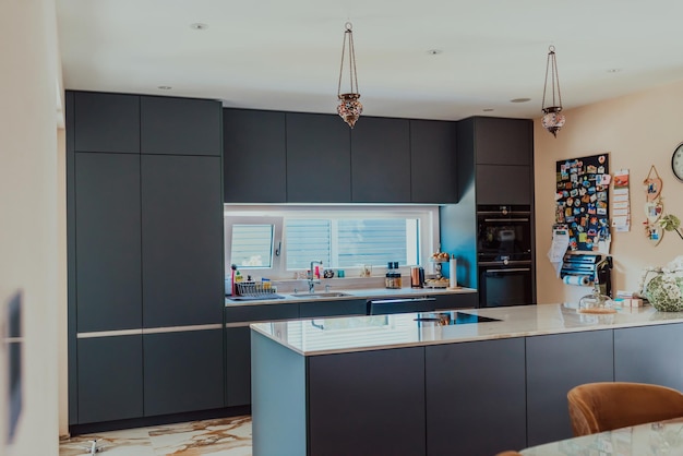 Modern gray kitchen with electronic devices and decorative items