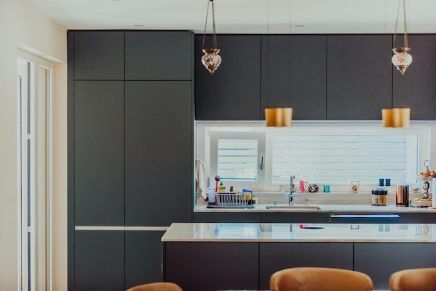 Modern gray kitchen with electronic devices and decorative items